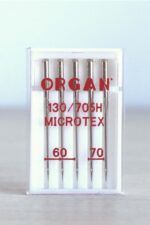 Cajita blanca con surtido de 5 agujas de coser a máquina. En la caja se puede leer en rojo la marca, ORGAN, el tipo de aguja (Microtex) y los grosores de la aguja: 60 y 70.