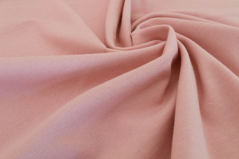 Primer plano de la textura de la tela de punto camiseta en color rosa palo