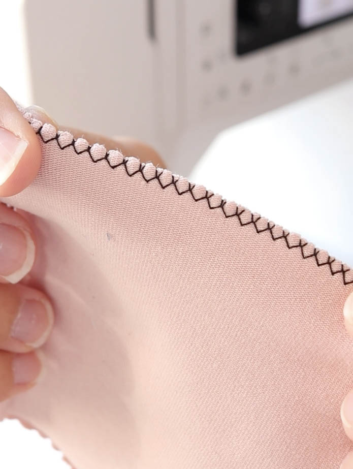Muestra de puntada zig zag en tela de punto de algodón orgánico GOTS en color rosa palo